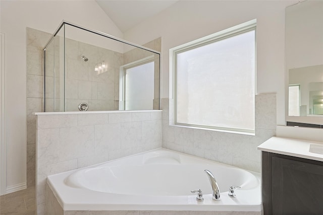 bathroom with plus walk in shower, vanity, and lofted ceiling