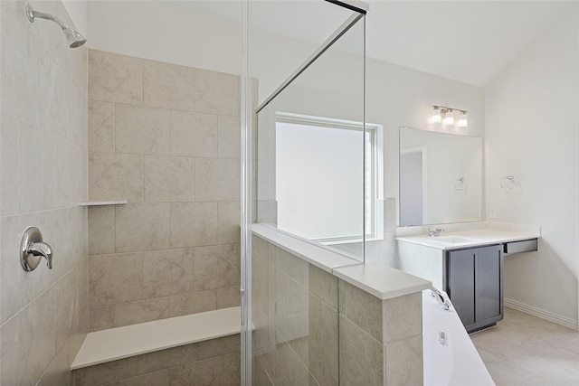 bathroom with a tile shower, tile patterned flooring, and vanity