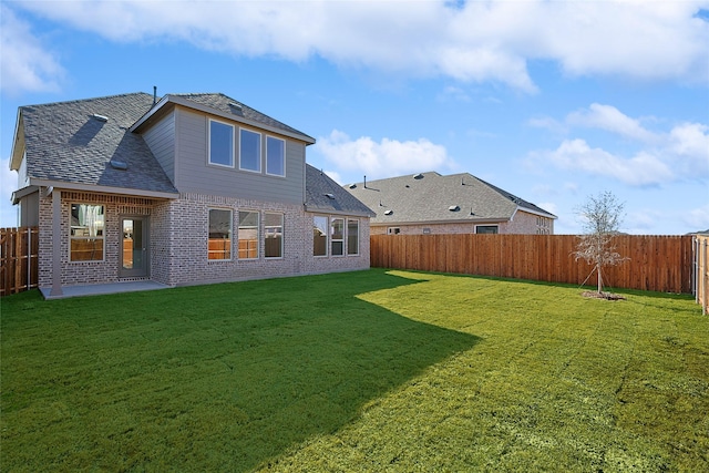 back of house featuring a patio area and a lawn