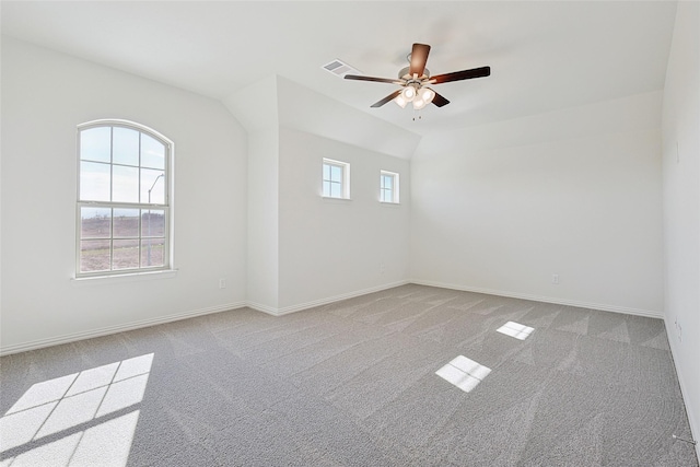 carpeted empty room featuring ceiling fan and lofted ceiling