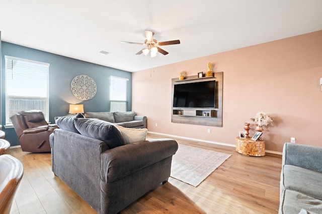 living room featuring light hardwood / wood-style flooring and ceiling fan