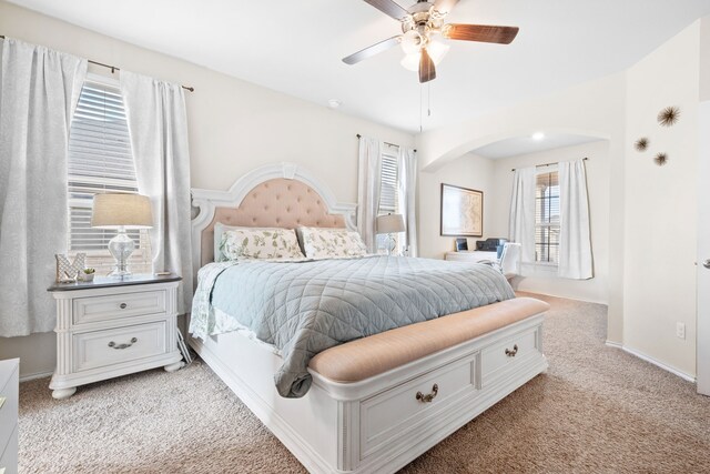 2816 Brosnan Rd, Waco, TX 76655 - bedroom with arched walkways, light carpet, baseboards, and a ceiling fan