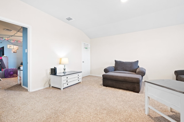 sitting room featuring light carpet and lofted ceiling