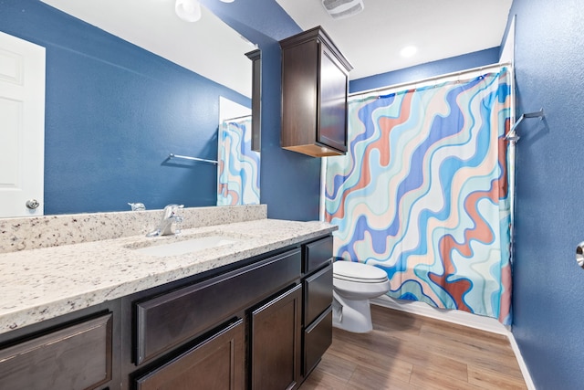 bathroom featuring a shower with curtain, vanity, toilet, and wood-type flooring