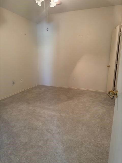 spare room featuring ceiling fan and carpet flooring