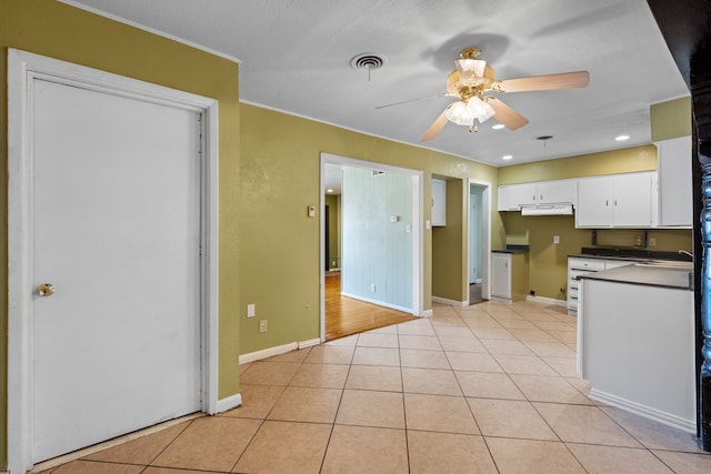 kitchen featuring white cabinets, a textured ceiling, sink, ceiling fan, and light tile patterned flooring