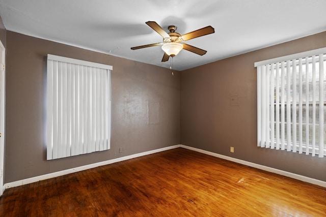 spare room featuring wood-type flooring and ceiling fan