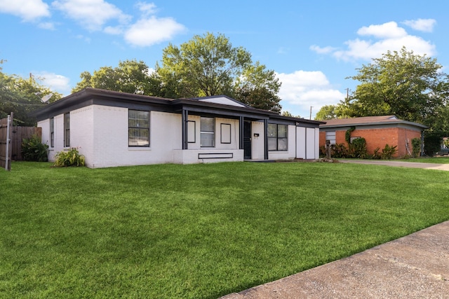 ranch-style home with a front lawn