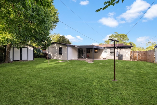 back of house featuring a storage unit, central air condition unit, a yard, and a patio