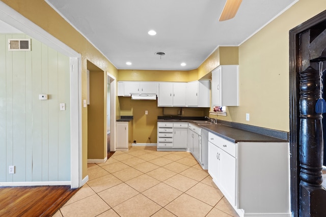 kitchen with white cabinets, light tile patterned flooring, and ceiling fan