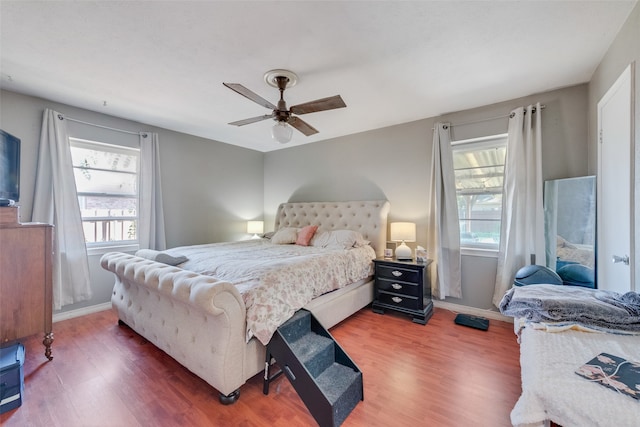 bedroom featuring ceiling fan and dark hardwood / wood-style floors