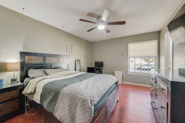 bedroom with ceiling fan and dark hardwood / wood-style floors