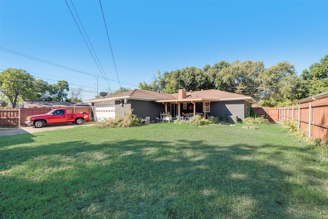 view of front of property featuring a garage and a front yard