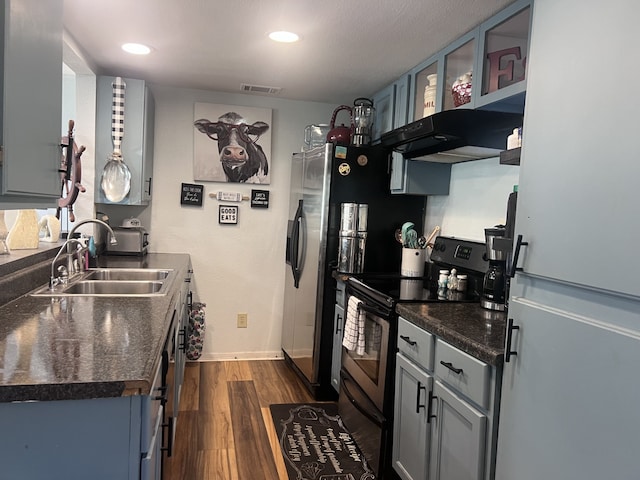 kitchen featuring electric stove, sink, dark wood-type flooring, white refrigerator, and exhaust hood