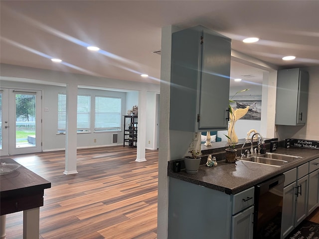 488 Briggs Blvd, East Tawakoni, TX 75472 - kitchen with dark countertops, a sink, gray cabinetry, dishwasher, and wood finished floors