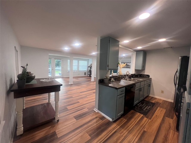 488 Briggs Blvd, East Tawakoni, TX 75472 - kitchen featuring dishwasher, dark countertops, a sink, dark wood-style floors, and recessed lighting