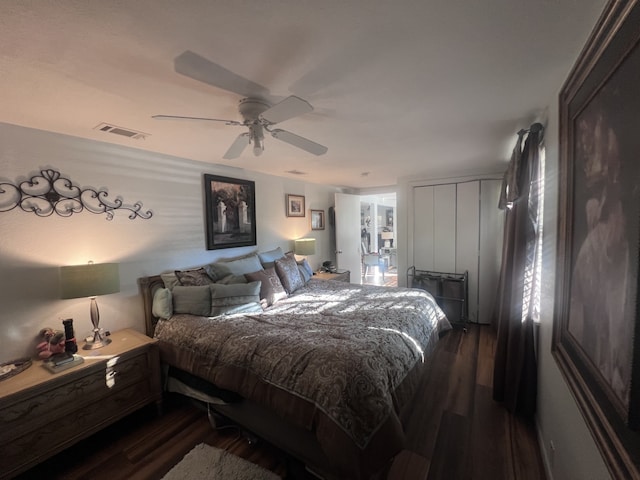 bedroom with dark hardwood / wood-style floors and ceiling fan