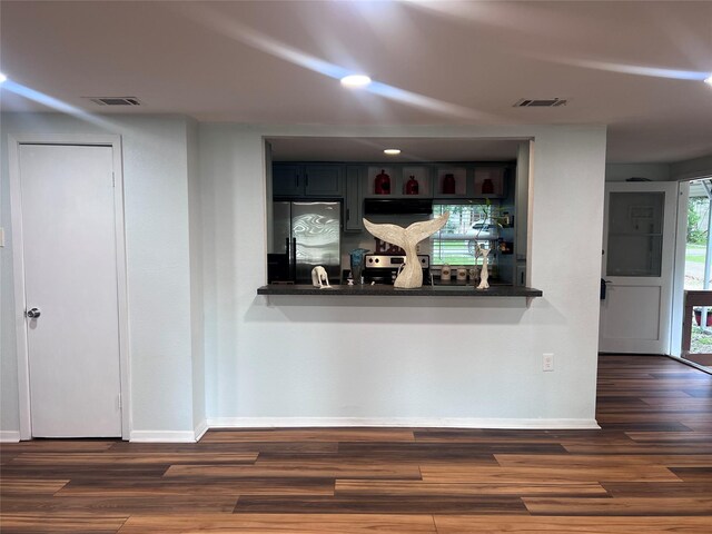 488 Briggs Blvd, East Tawakoni, TX 75472 - detailed view of stainless steel refrigerator, baseboards, wood finished floors, extractor fan, and recessed lighting