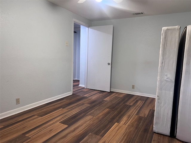 488 Briggs Blvd, East Tawakoni, TX 75472 - unfurnished bedroom with dark wood finished floors, baseboards, and a ceiling fan