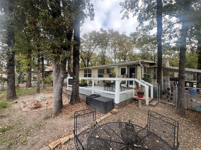 back of property featuring a wooden deck