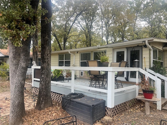 488 Briggs Blvd, East Tawakoni, TX 75472 - rear view of house with a wooden deck and view of wooded area