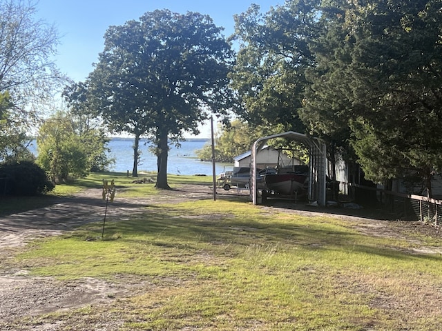 488 Briggs Blvd, East Tawakoni, TX 75472 - view of green lawn with a water view and a carport