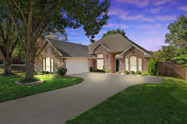 view of front of home with a lawn and a garage