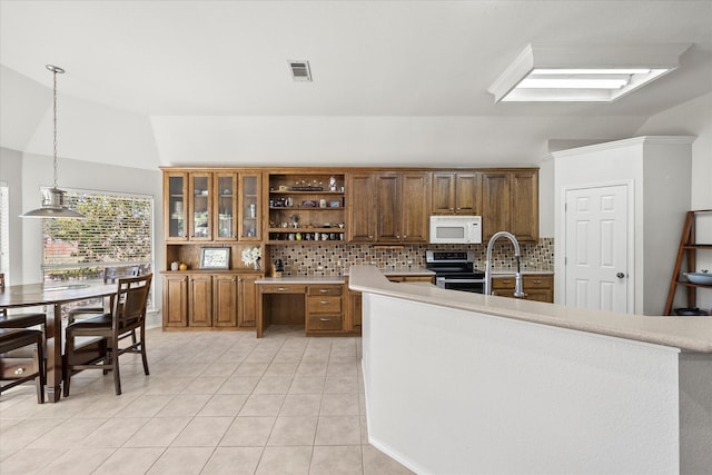 kitchen featuring pendant lighting, backsplash, vaulted ceiling with skylight, stainless steel electric range oven, and light tile patterned floors