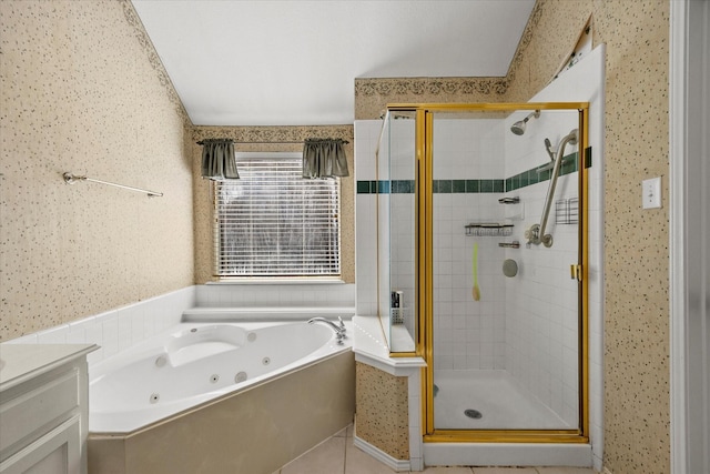 bathroom with tile patterned floors, independent shower and bath, and vanity