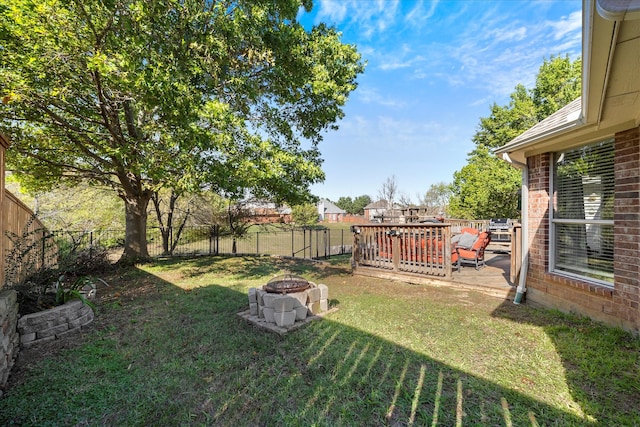 view of yard featuring an outdoor fire pit and a wooden deck