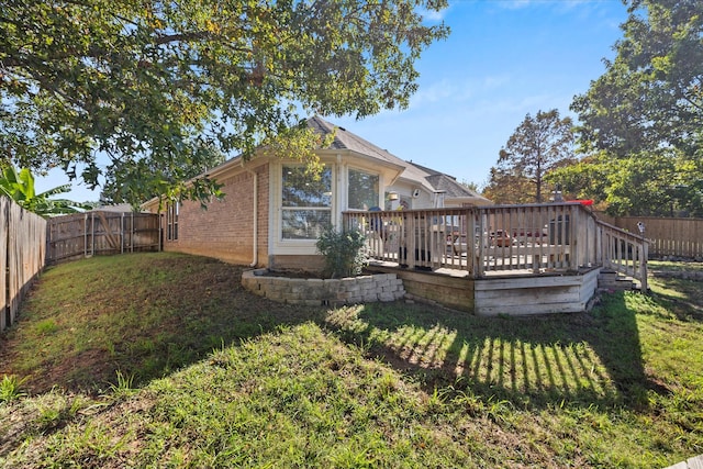 back of property featuring a yard and a deck