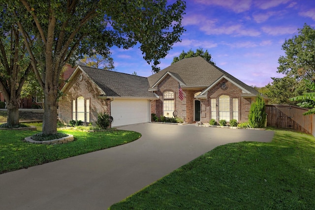 view of front facade with a yard and a garage