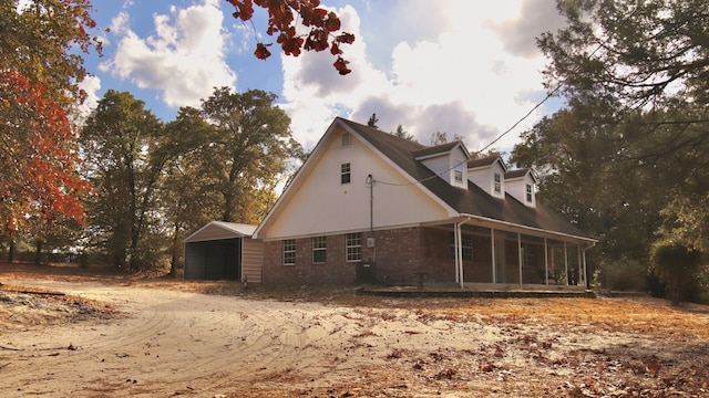 view of property exterior featuring a garage and an outbuilding