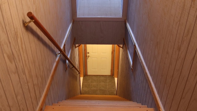 staircase with wood walls