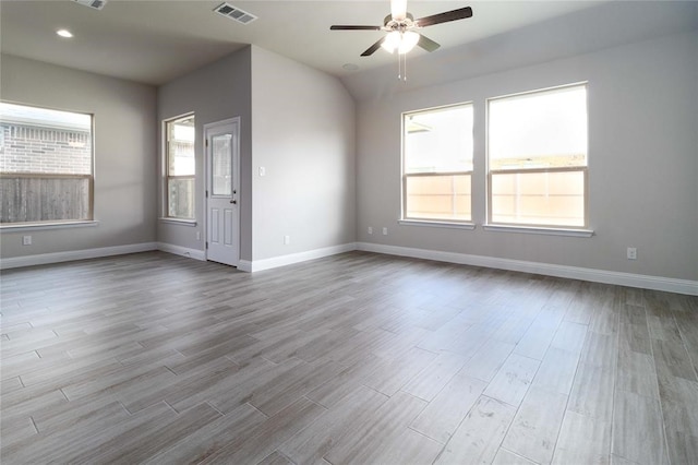 empty room with light wood-type flooring, ceiling fan, and a healthy amount of sunlight