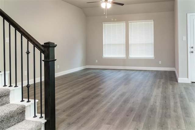 foyer entrance with hardwood / wood-style floors, vaulted ceiling, and ceiling fan