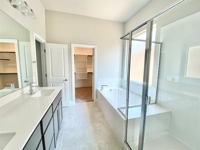 bathroom with tile patterned flooring, vanity, and separate shower and tub