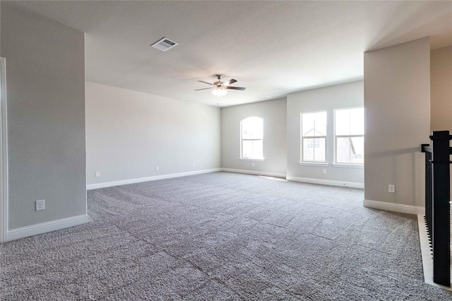 carpeted spare room featuring ceiling fan