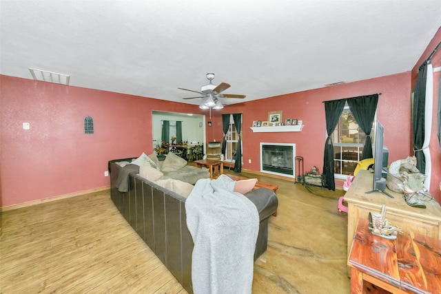 living room with ceiling fan and light hardwood / wood-style floors