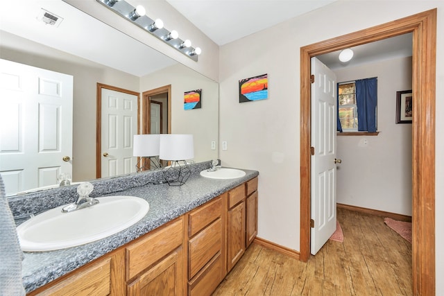 bathroom with hardwood / wood-style floors and vanity