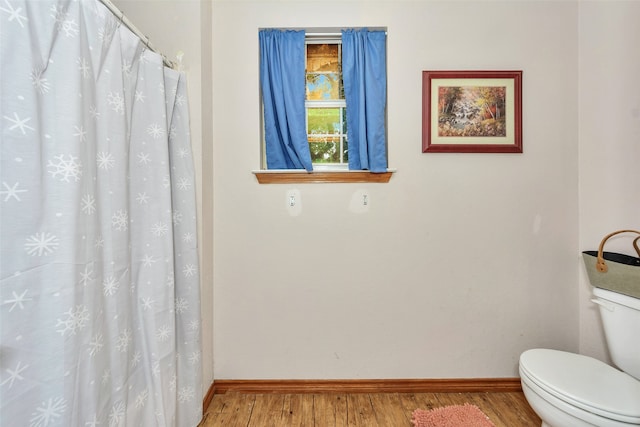 bathroom featuring hardwood / wood-style floors and toilet