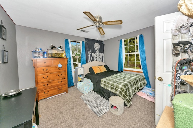 bedroom featuring ceiling fan and carpet