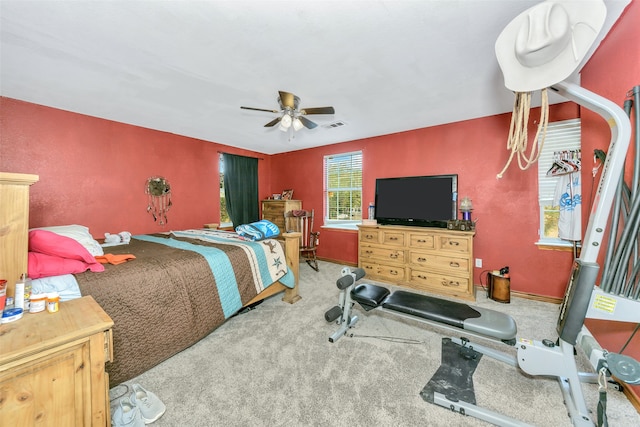 bedroom with ceiling fan and light carpet