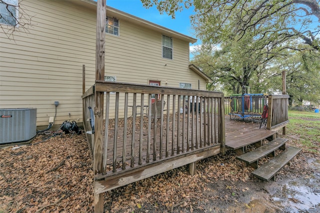 wooden deck with a trampoline and central air condition unit