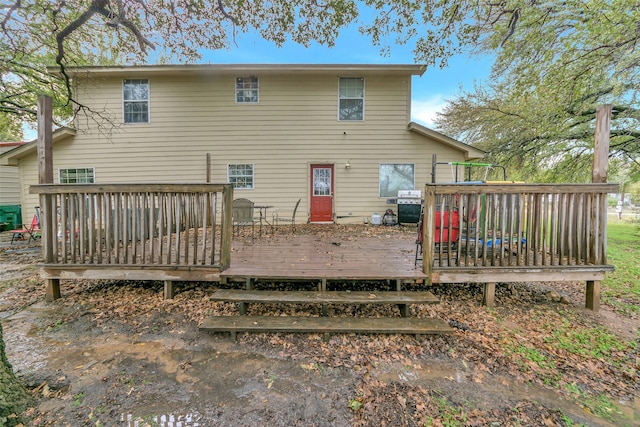 back of property featuring a wooden deck