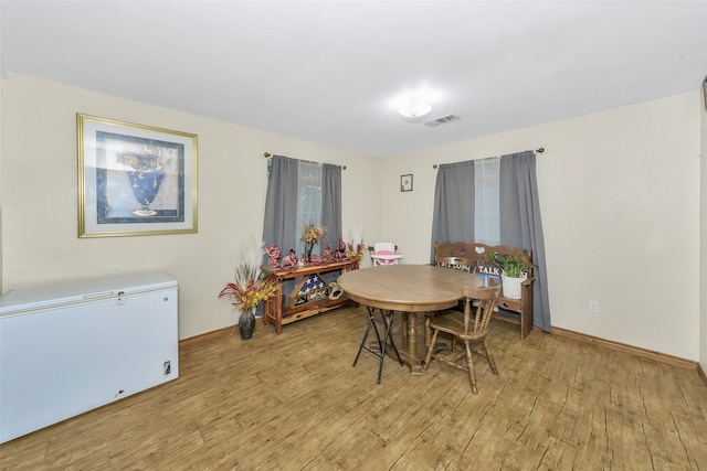 dining area with light hardwood / wood-style flooring