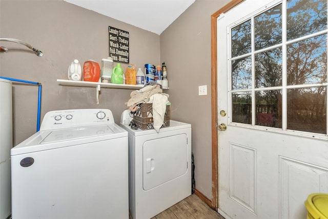 laundry area featuring separate washer and dryer and light hardwood / wood-style floors