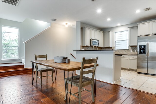 dining space with light hardwood / wood-style floors