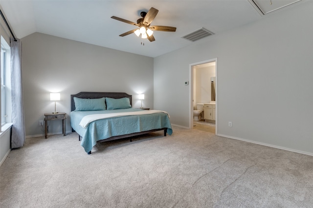 carpeted bedroom with ceiling fan, connected bathroom, and lofted ceiling