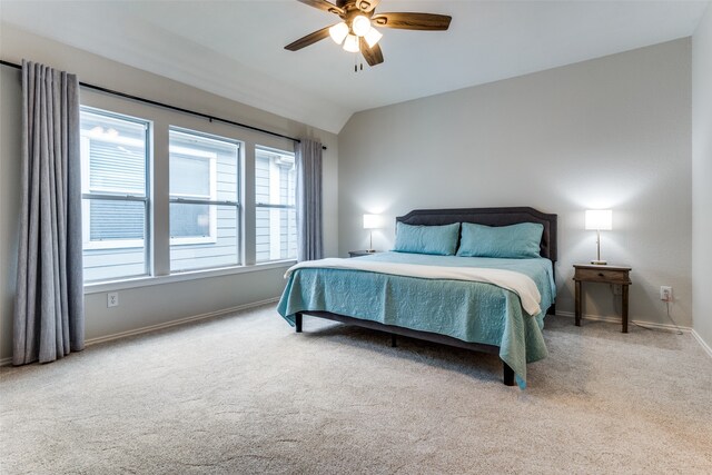 carpeted bedroom featuring lofted ceiling and ceiling fan